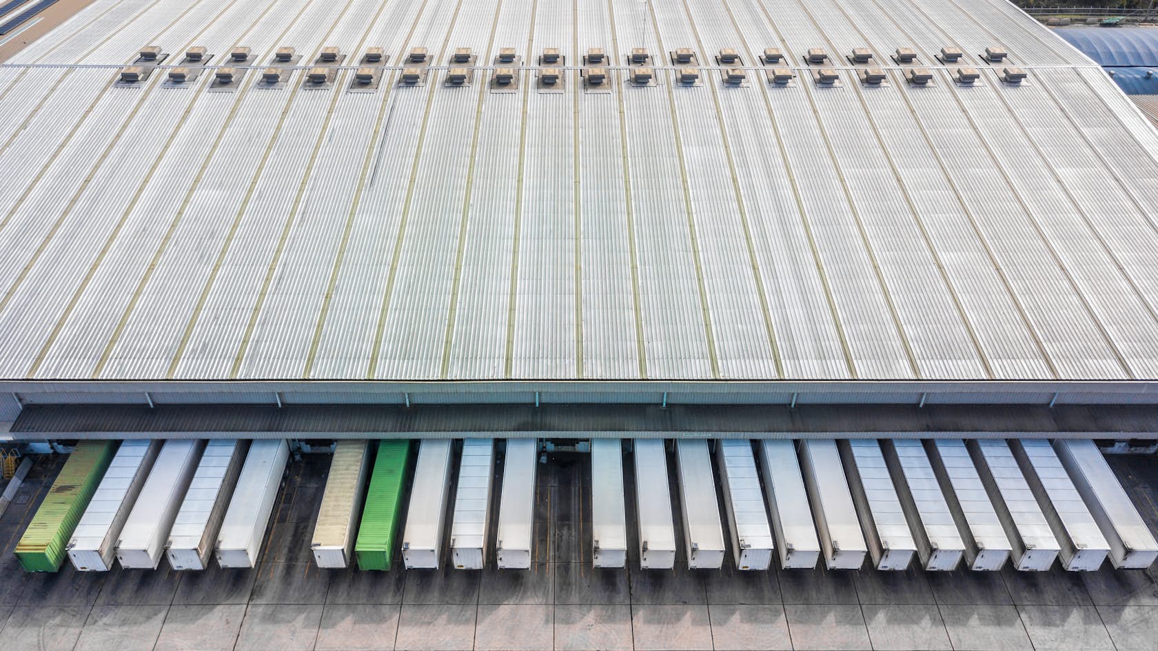 Industrial logistics large lorries warehouse shed shutterstock 1135250966